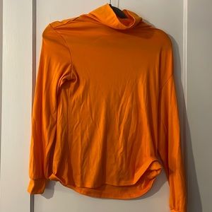 Bright orange turtleneck sweater